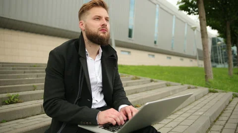 Handsome elegant man working outside, focused laptop, enjoying, bearded hipster Stock-Footage 134599773
