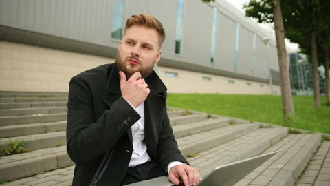 Handsome elegant man working outside, focused laptop, enjoying, bearded hipster Stock Footage 134669129