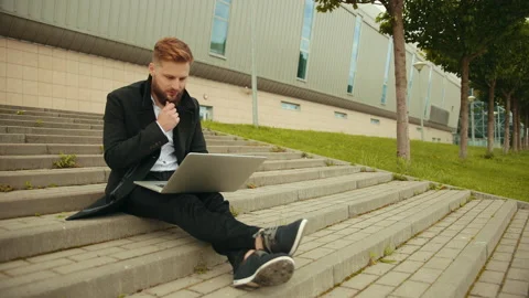Handsome elegant man working outside, focused laptop, enjoying, bearded hipster Stock Footage 134722926