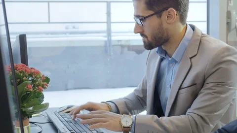 Handsome employee working on the computer in the modern office Stock Footage 73990284