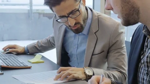 Handsome employee working on the computer in the modern office Stockbeeldmateriaal 73990427