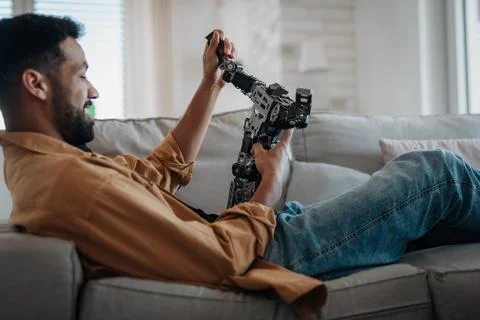 Handsome engineer student working on robot project at home. 写真素材