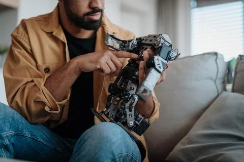 Handsome engineer student working on robot project at home. 스톡 사진