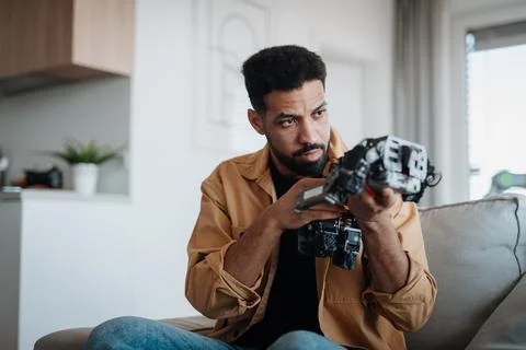 Handsome engineer student working on robot project at home. 写真素材