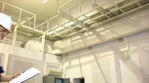 Handsome engineer is working on his project. He is holding a blueprint and Stock Footage 60972802