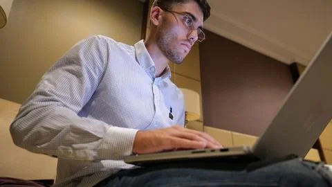 Handsome entrepreneur use notebook for work sitting in armchair at home inter Stock Photos