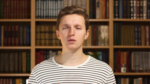 Handsome European guy close up. The guy thinks in front of the camera. Thoughts Stock Footage 146276374