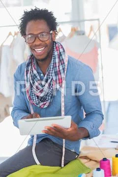 Handsome fashion designer using digital tablet Stock-Fotos