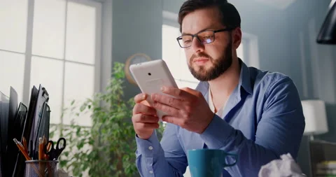 Handsome focused man in glasses working at home office, using digital tablet to 库存影片 151102231
