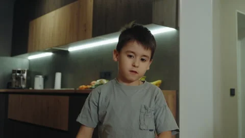 Handsome friendly cheerful little boy gesticulating with fingers, wearing gray t Stock Footage 264635149