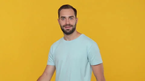 Handsome fun bearded young man 20s in basic casual blue t-shirt come in looking Stock Footage 148282831