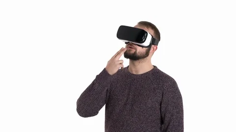 Handsome funny man wearing a virtual reality headset is smoking, surprised by Stock Footage 121201944