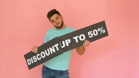 Handsome funny smiling guy with discount up to 50% sign dancing isolated over Stock Footage 116454230