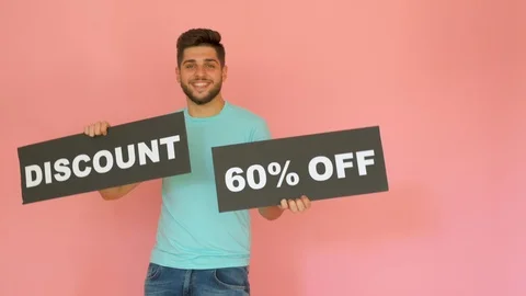 Handsome funny smiling guy with discount 60% off sign dancing isolated over p Stock Footage 116454356