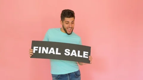 Handsome funny smiling guy with final sale sign dancing isolated over pink Stock Footage 116455197