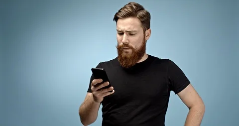 Handsome ginger haired caucasian young hipster man with mustache and beard using Stock Footage 112296911