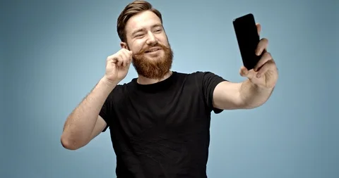 Handsome ginger haired hipster man with mustache and beard taking a selfie and Stock Footage 112296699