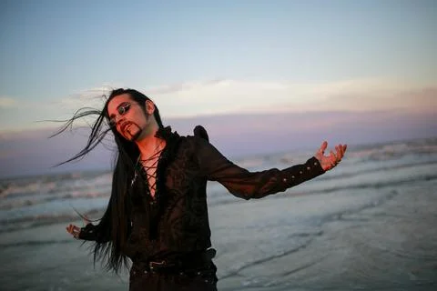 Handsome goth dark vampire emo guy with long hair Stock Photos