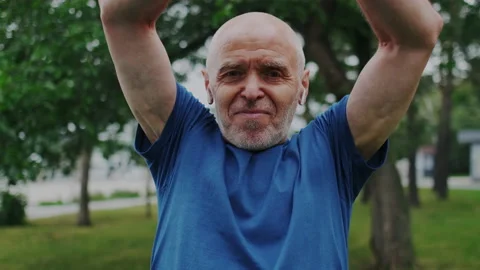 Handsome Gray-Haired Old Man after Hard Intense Physical Exercise. He Standing Stock Footage 148467221