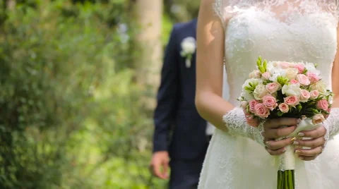 Handsome groom comes to bride behind her Stock Footage 63757299