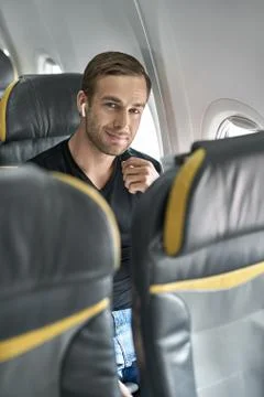 Handsome guy in airplane Stock-Fotos
