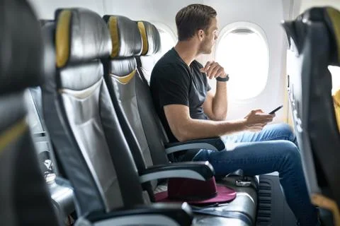 Handsome guy in airplane Stock Photos