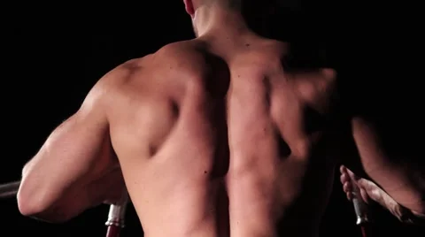 Handsome guy athlete pumping his back on the trainer Stock Footage 62758810