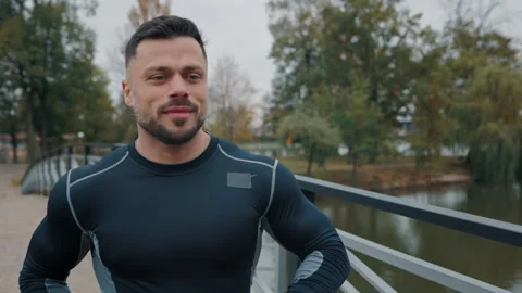 Handsome Guy Athlete Running on Bridge. Positive Jogger Training. Male Doing Stock Footage 267715403