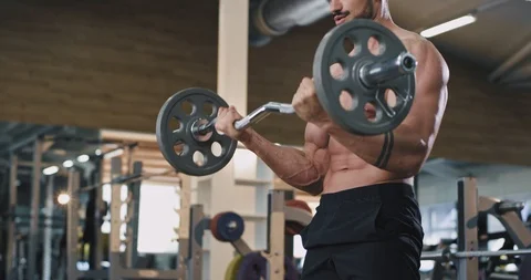 Handsome guy athletic man have workout day on his gym class lifting up the Stock Footage 114765526