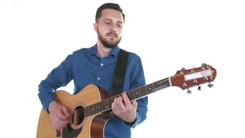 Handsome guy with beard playing acoustic guitar. White background. Isolated Stock Footage 135235346