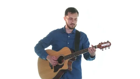 Handsome guy with beard playing acoustic guitar. White background. Isolated Stock Footage 135235410