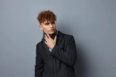 Handsome guy Black coat posing fashion Lifestyle unaltered Stock Photos