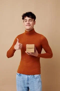 Handsome guy brown turtleneck posing fashion light background unaltered Stock Photos