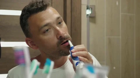 Handsome guy brushes teeth 스톡 동영상 157686569