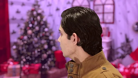 Handsome guy with Christmas background, 4K ProRes Video stock 164639173