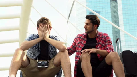 Handsome guy consoling his friend during his friend crying, sad because he g Stock Footage 137444003
