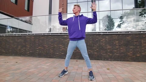 Handsome guy dancing hip hop, modern dance free style on the city street. Stock Footage 139758259