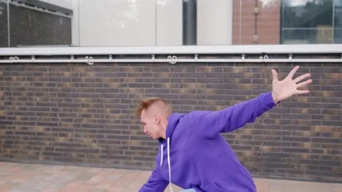 Handsome guy dancing hip hop, modern dance free style on the city street. Stock Footage 139758325