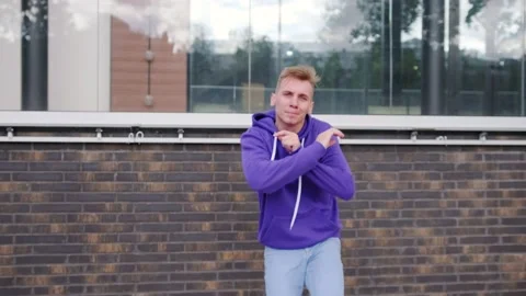 Handsome guy dancing hip hop, modern dance free style on the city street. Stock Footage 139758351