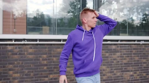 Handsome guy dancing hip hop, modern dance free style on the city street. Stock Footage 139758385