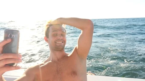 A handsome guy does selfie on board a yacht. Stock Footage 80795878