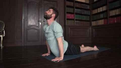 Handsome Guy Doing Yoga Indoors in Library Stock Footage 152571087
