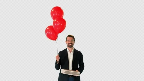 Handsome guy in an elegant suit with a gift box and balloons walking, Alpha Stock-Footage 151158189