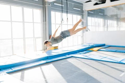 Handsome guy is falling on the mats Stock Photos