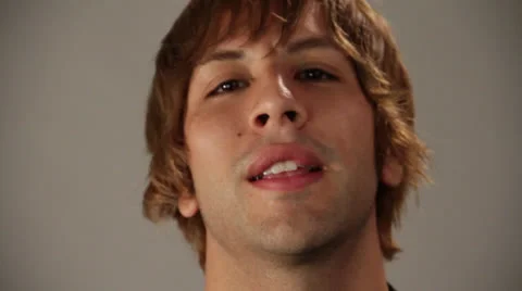 Handsome guy gives varies face expression in front of camera Stock Footage 22843308