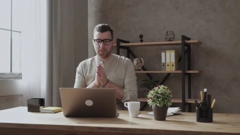 Handsome guy with glasses communicates having video call over laptop in the Video stock 132521466