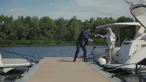 Handsome guy has fun with his girlfriend at the pier Stock Footage 89907058