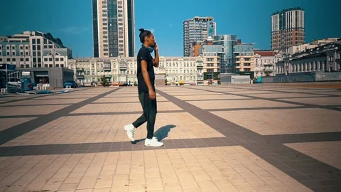 Handsome guy has phone conversation walks on the square Stock Footage 127856113