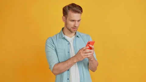 Handsome guy hold telephone read news post rejoice crazy lucky sale reaction Stock Footage 161529965