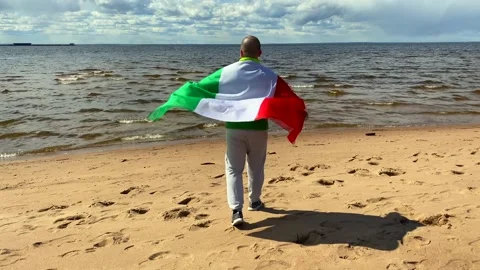 Handsome guy with the italian flag behind Video stock 130435646
